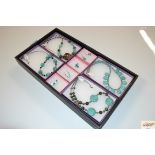 A tray of handmade jewellery; semi precious stones