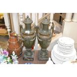 A pair of classical bronze and marble urns on plin