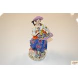 A German porcelain figure of a flower girl with at