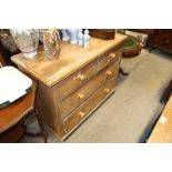 An antique stripped pine chest of two short and tw