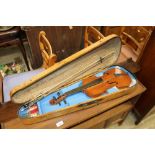 A violin and bow in pine case