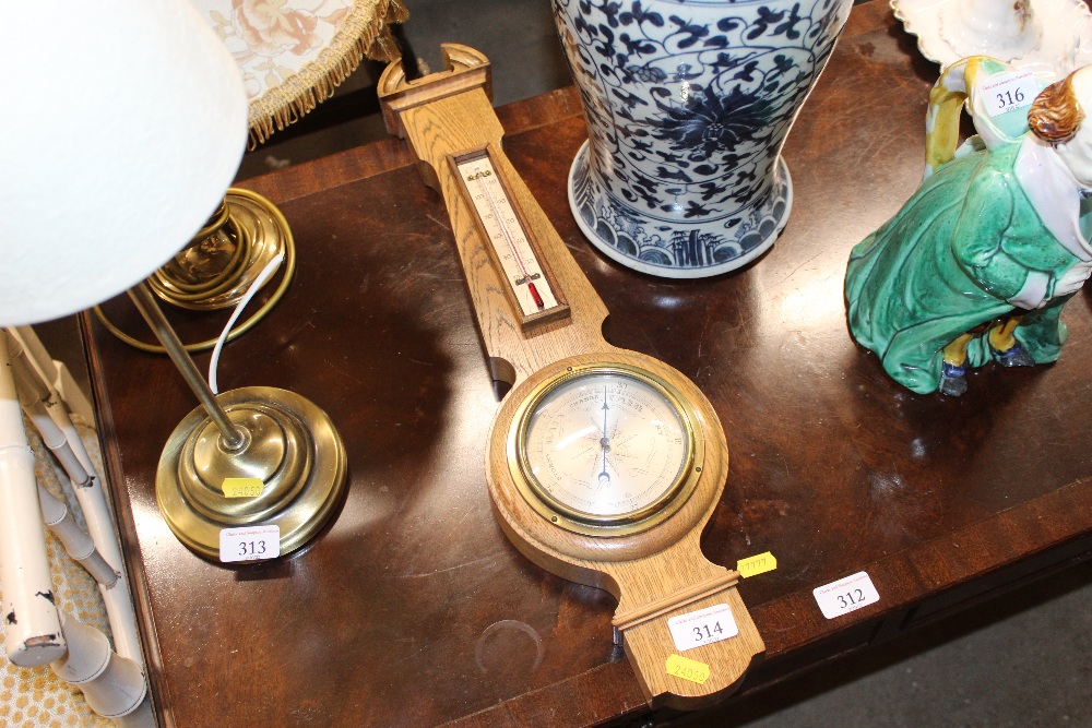 An oak cased banjo shaped barometer