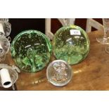 Two large green glass bubble decorated dumps; and