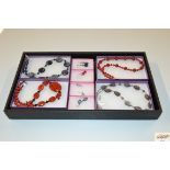 A tray of various hand made jewellery, semi precio