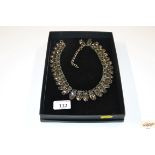 A boxed diamante necklace