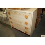 A modern pine effect chest fitted four drawers