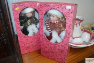 Two boxed dress dolls