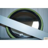 A wall mirror with bike tyre frame