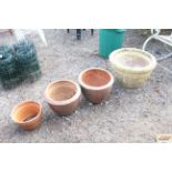 Three terracotta planters and another