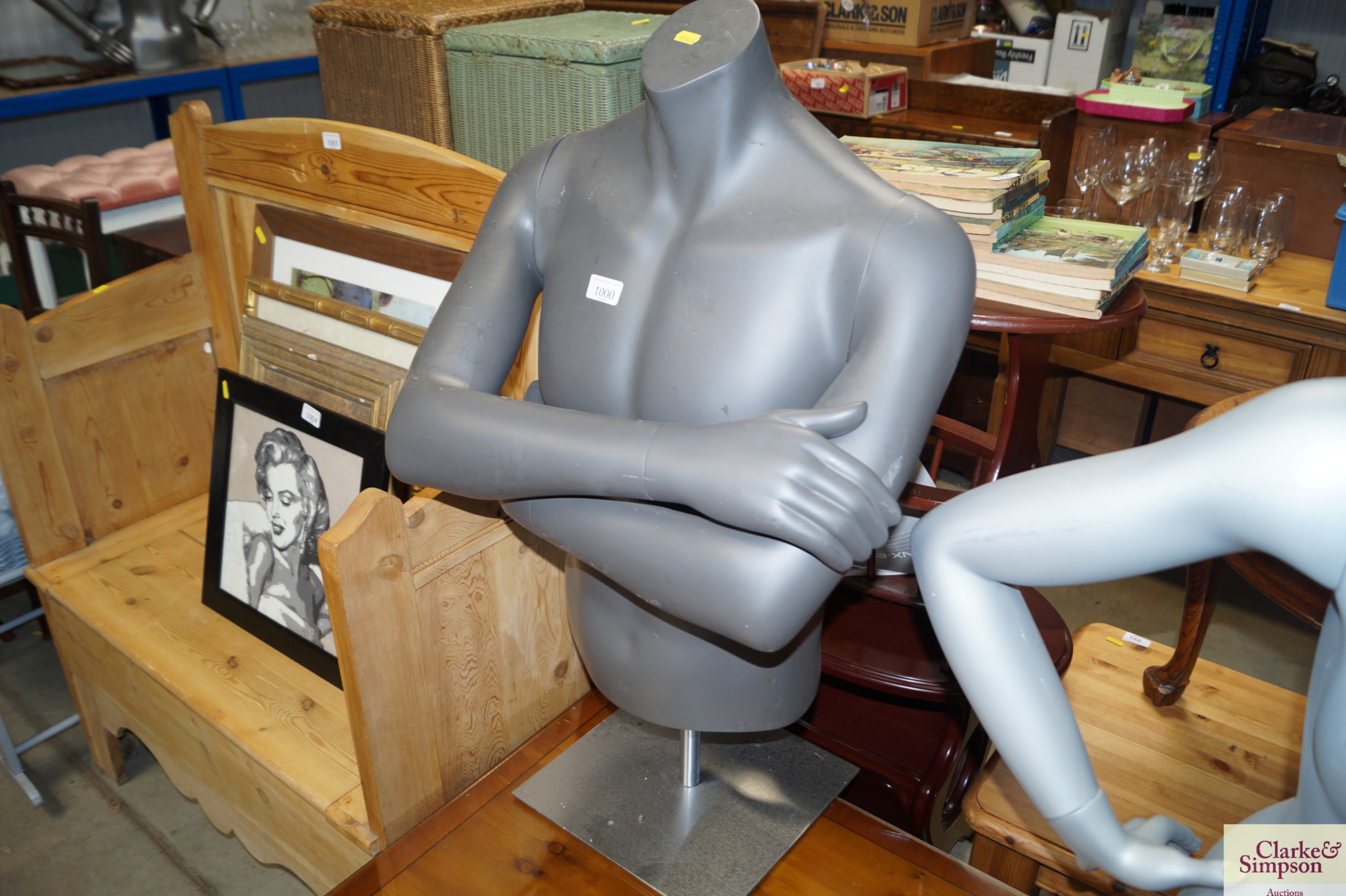 A male mannequin torso on stand