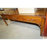 A reproduction yew wood coffee table fitted three