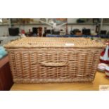 A wicker picnic hamper lacking contents