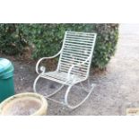 A cream painted metal garden rocking chair