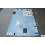 An approx. 3'6" x 5'6" modern wool rug