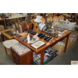 A teak extending dining table with one extra leaf