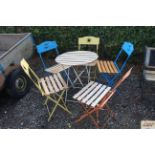 A metal and wooden garden table and a five chairs