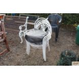Four white metal garden chairs and cushions