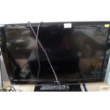 A Toshiba flat-screen TV with remote control