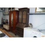 A 19th Century bureau bookcase raised on squat cabriole supports