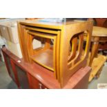 A teak nest of three occasional tables