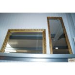 An oblong wall mirror contained in gilt frame toge