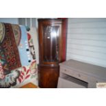 A reproduction mahogany corner cabinet