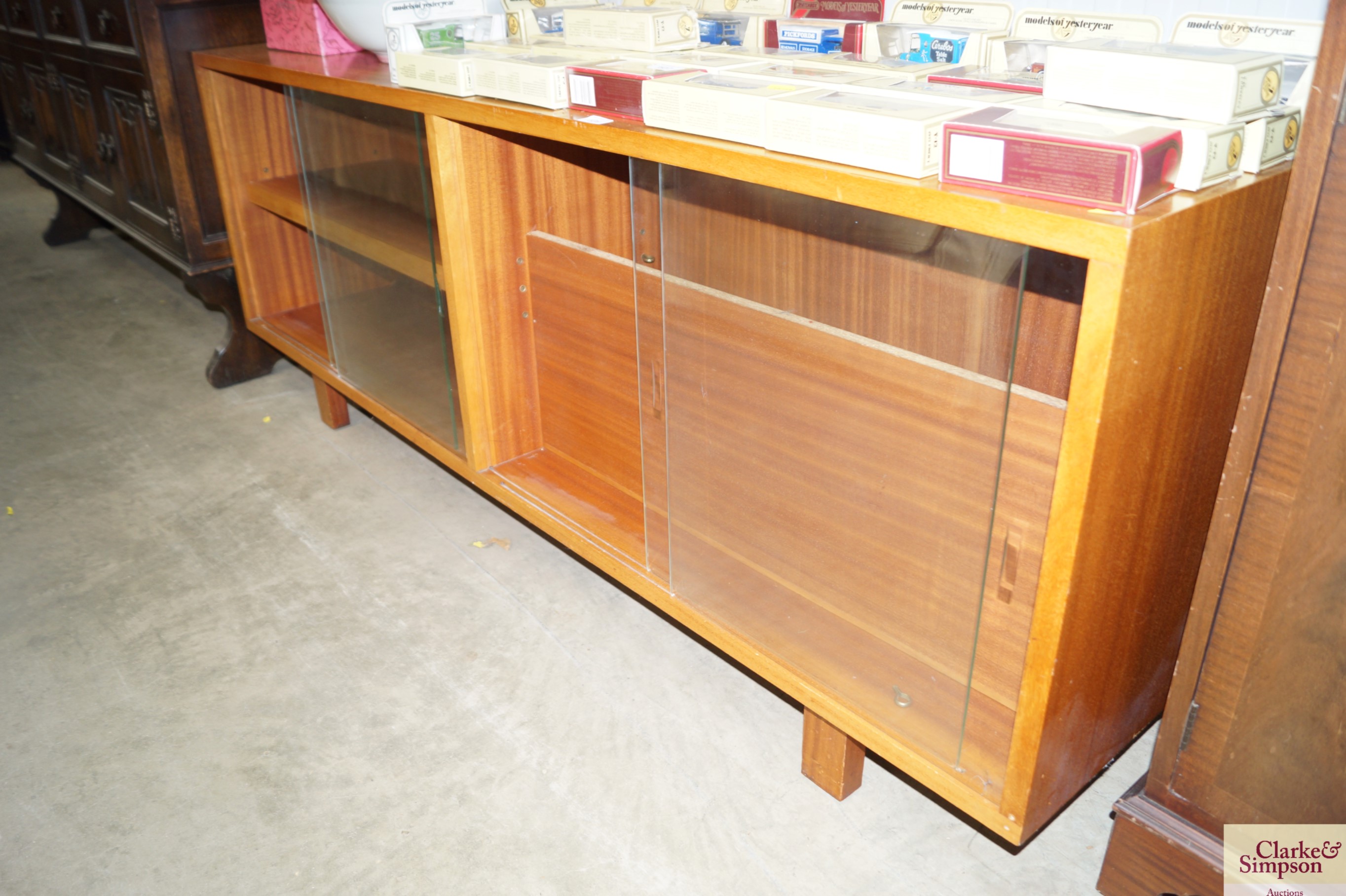 A teak and glass fronted bookcase