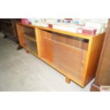 A teak and glass fronted bookcase