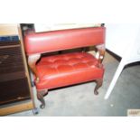 Two red leather upholstered button down foot stool