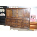 An oak and linen fold decorated side board