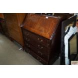 A reproduction mahogany bureau fitted four drawers