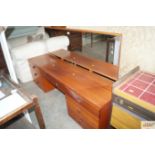 A mirror backed teak sideboard