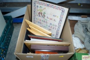 A box of various picture frames and a modern sampl