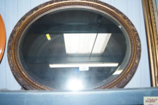 A bevel edged oval wall mirror