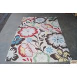 An approx. 6'11" x 5' modern wool rug with floral
