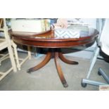 A reproduction mahogany circular coffee table