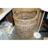 A wicker twin handled log basket