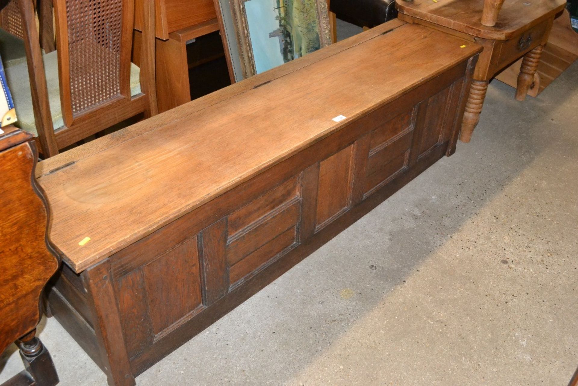 An oak panelled storage box of narrow proportions