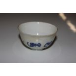 An Oriental bat decorated blue and white tea bowl