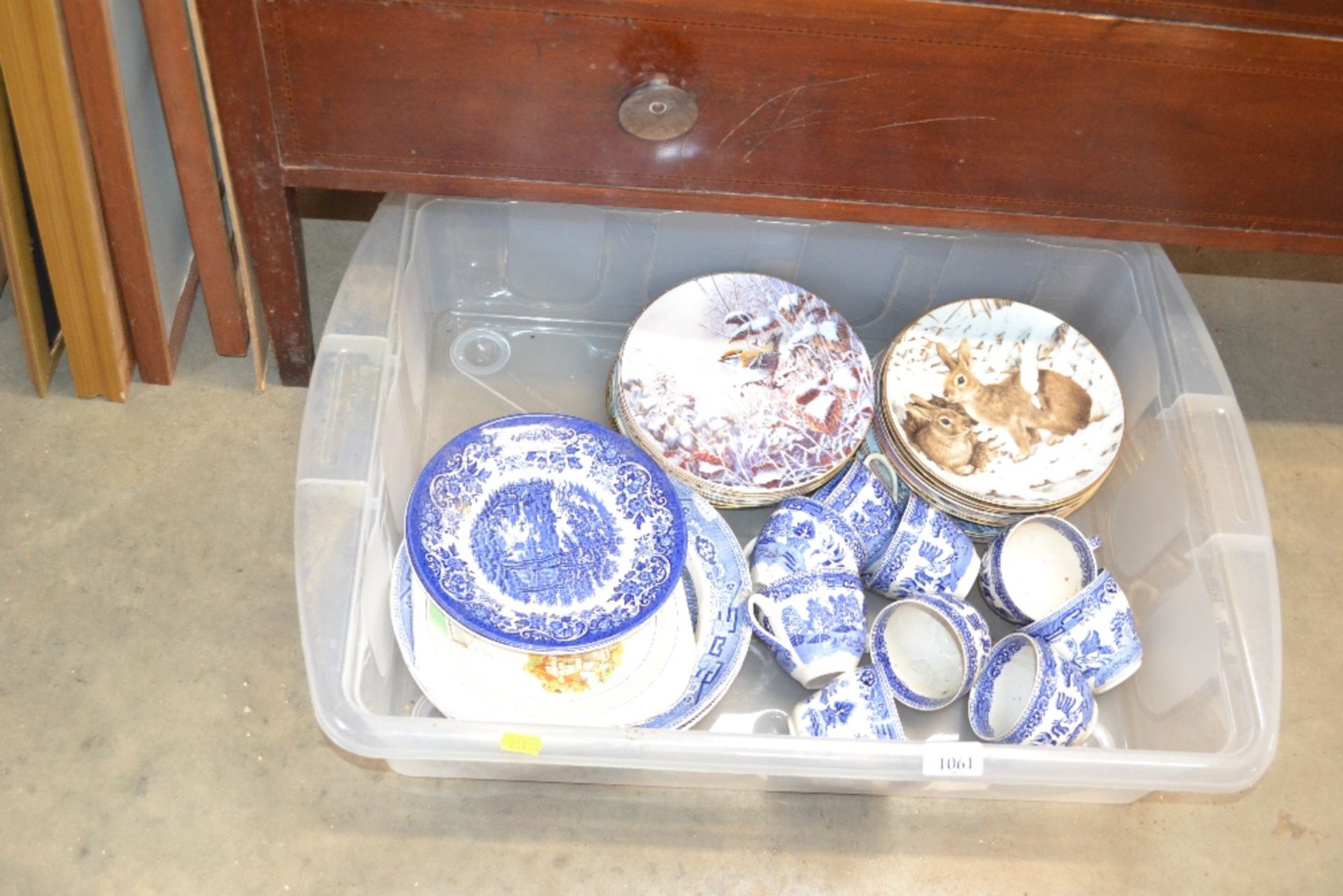 A box containing various china to include blue and