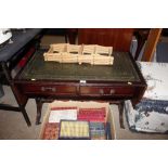 A sofa table with green leather inset top fitted t