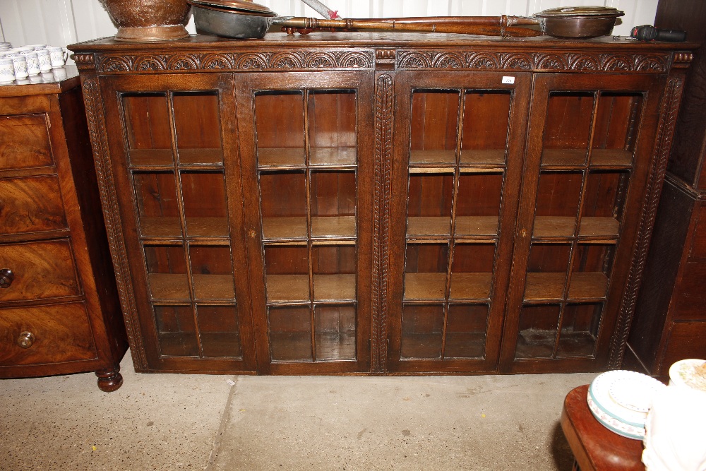 A large four door carved oak bookcase