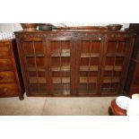 A large four door carved oak bookcase
