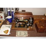 A Serata walnut cased sewing machine, retailed by