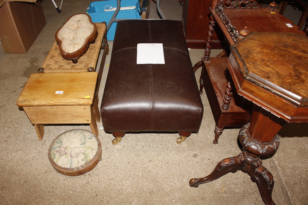 A brown leather upholstered pouffe raised on brass