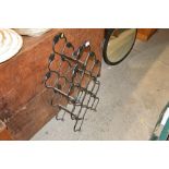 A wrought iron wine rack with leaf decoration