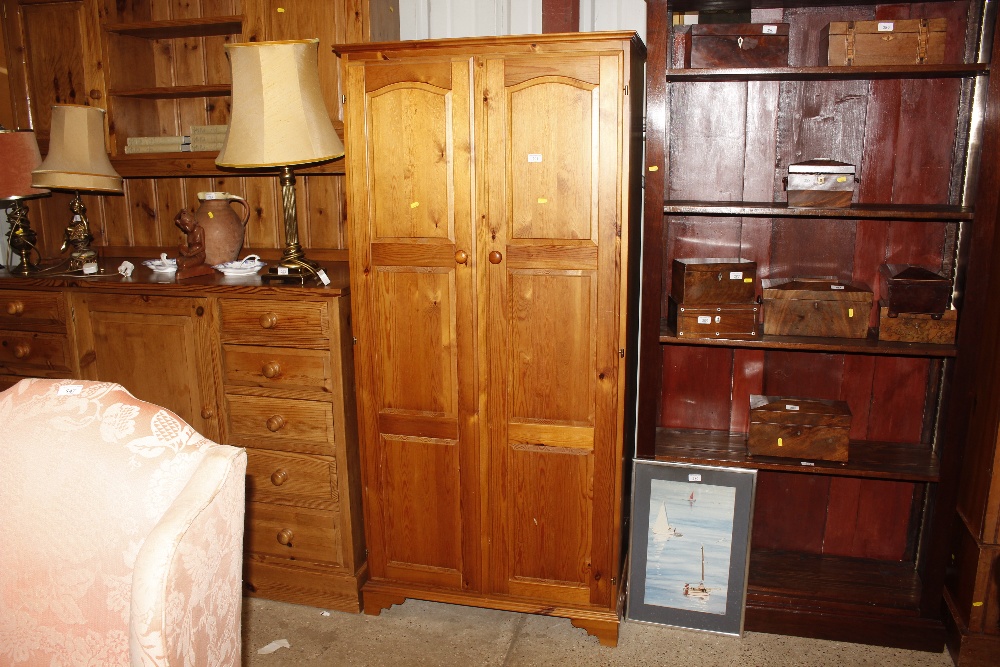 A modern pine two door wardrobe