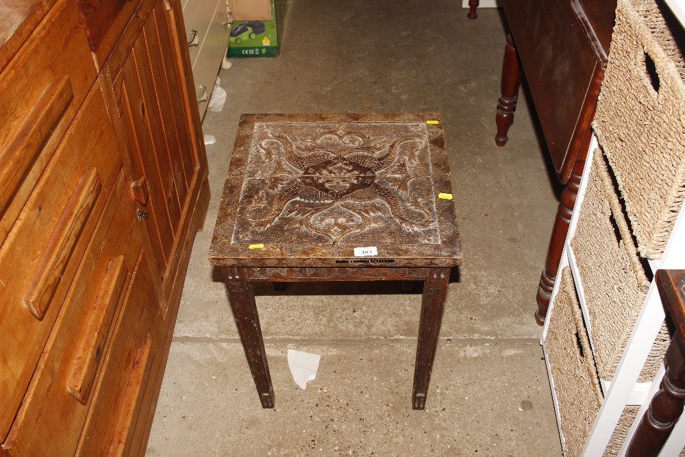 A carved oak side table AF