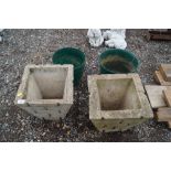 Two concrete plant pots together with two others