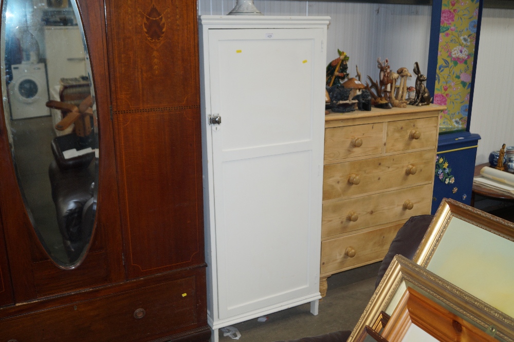 A white painted storage cupboard